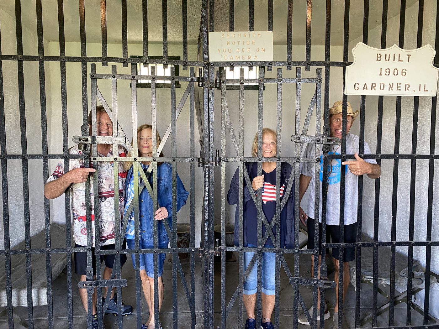 Visitors posing behind bars inside the Gardner Two-Cell Jail